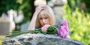 Grief Depression: Lady in cemetery at headstone